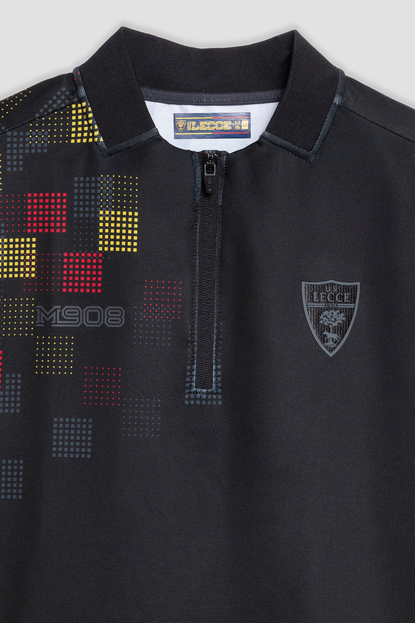 Black half-zip pre-match top with geometric pattern